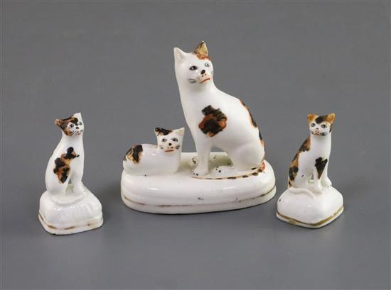 A Staffordshire porcelain group of a seated cat and kitten and two similar figures of kittens, c.1835-50, H. 6.1cm and 4cm